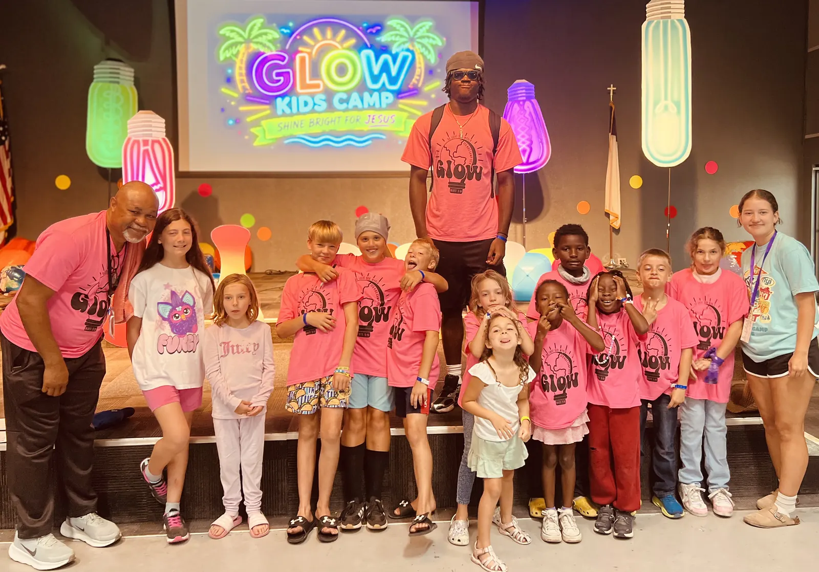 A church group in pink camp shirts on the GLOW stage