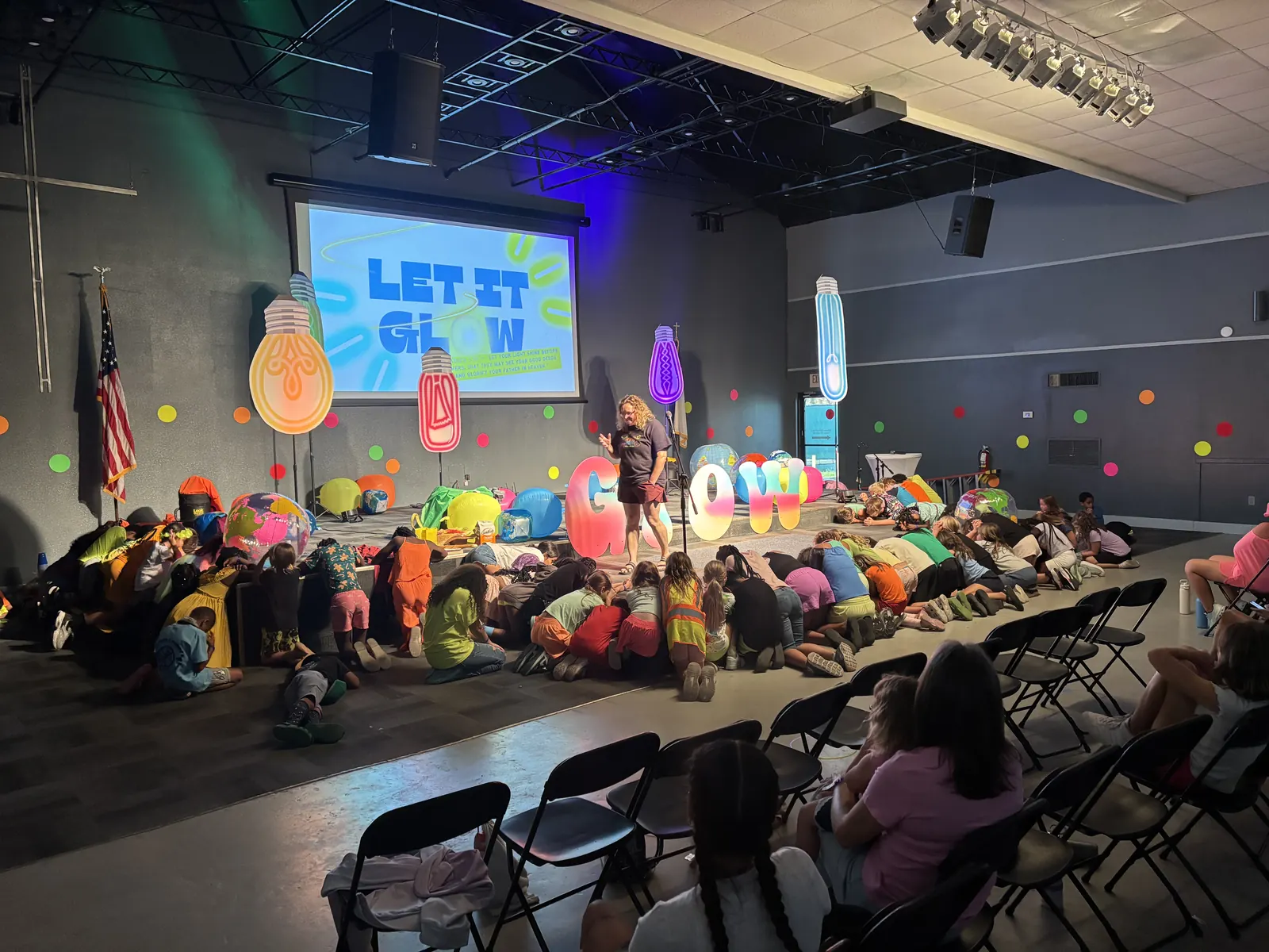 Campers gathered in front of the Let It GLOW stage