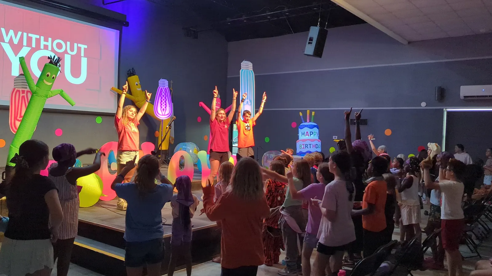 Campers with hands raised in worship