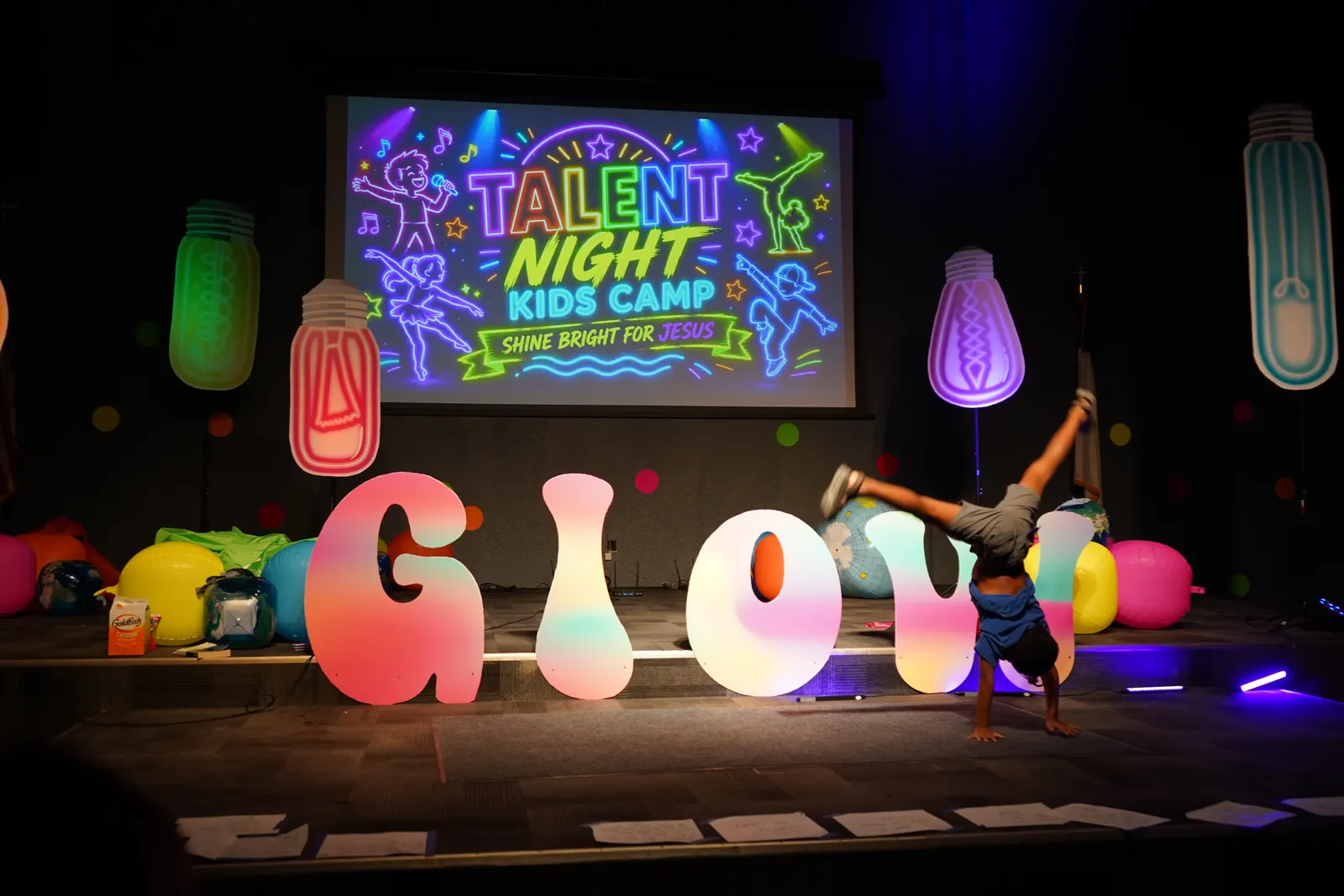 A camper flipping across the stage at Talent Night