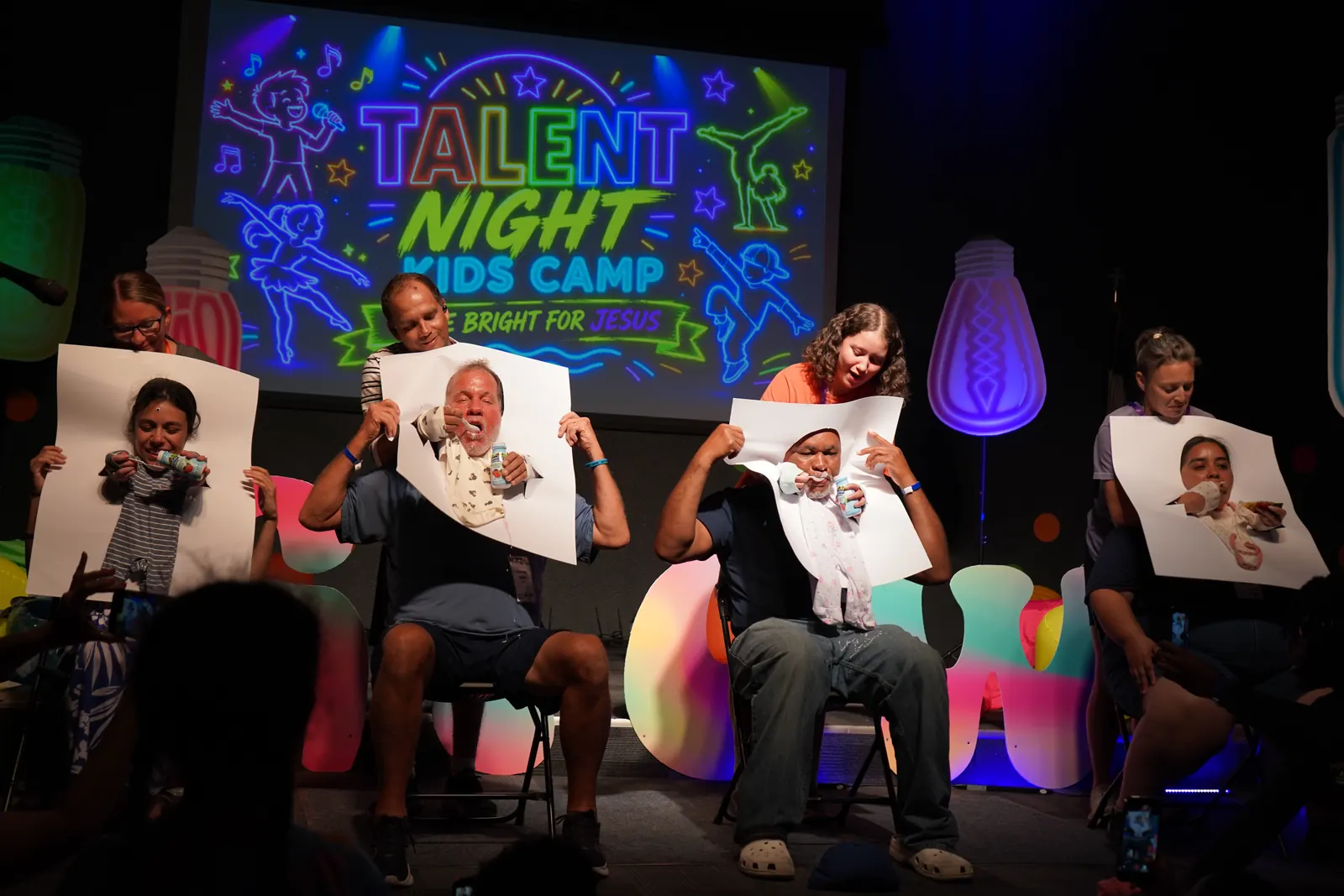 Talent Night, with leaders holding up silly photos