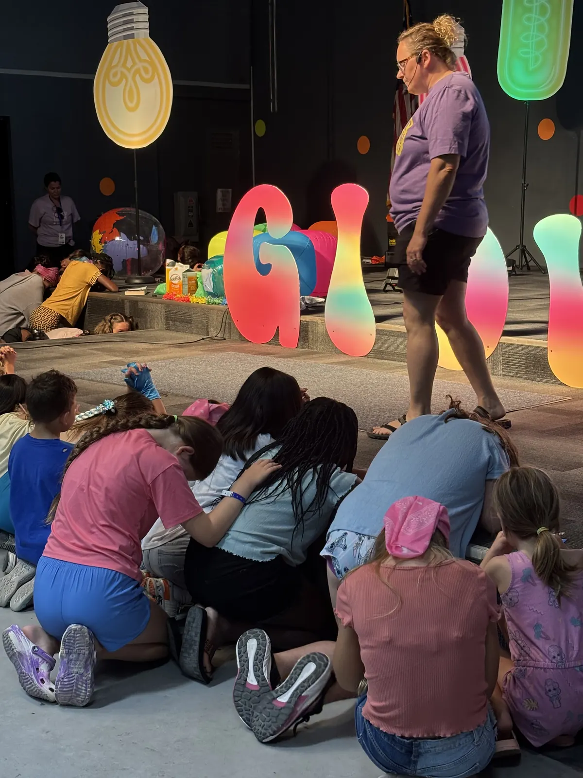 Campers gathered on the chapel floor with a leader