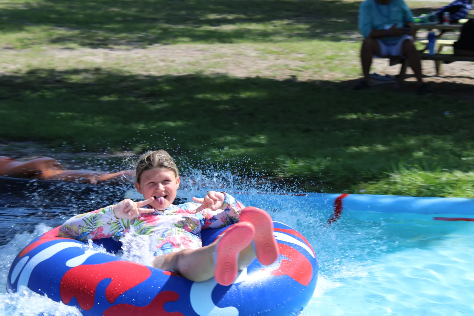 A camper splashing at the end of the slip 'n slide