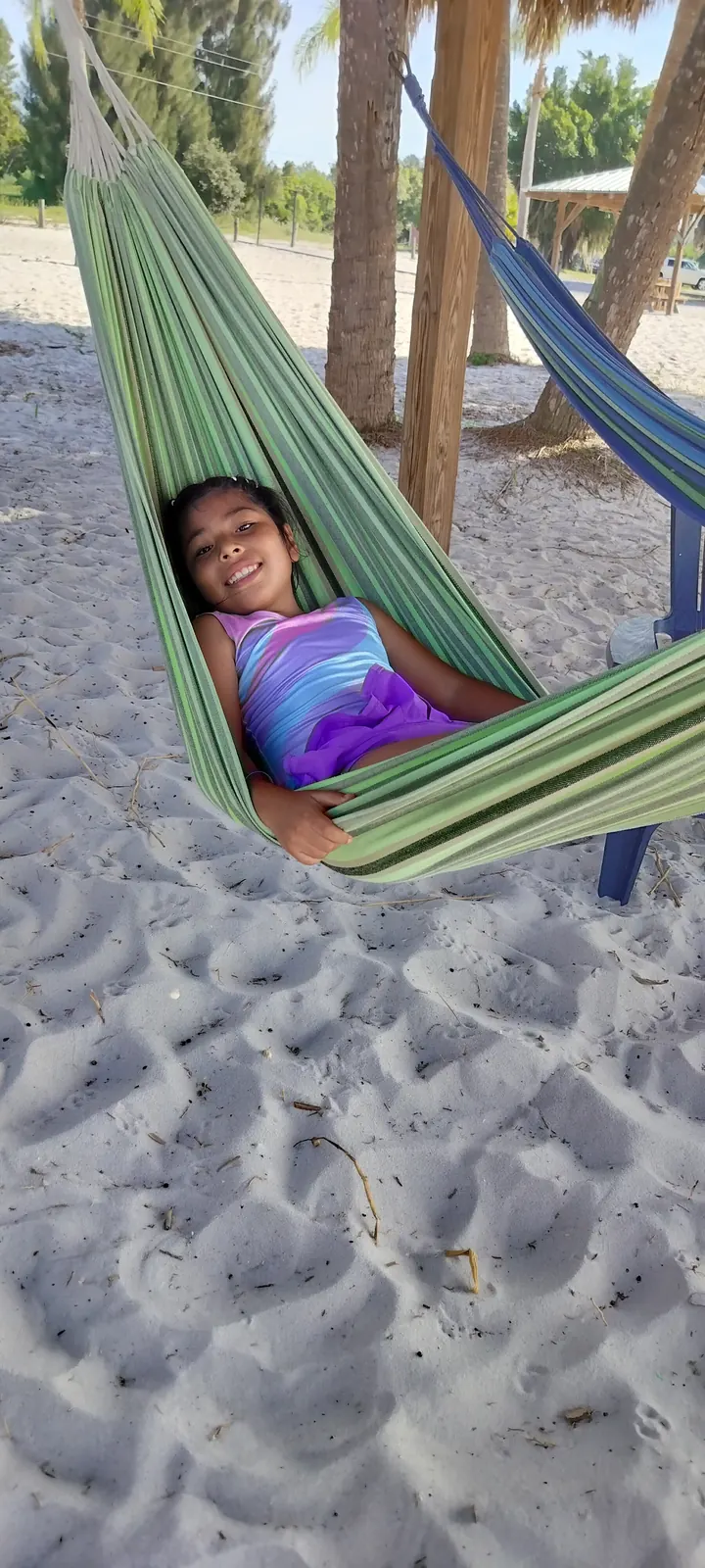 A camper relaxing in a hammock on the beach